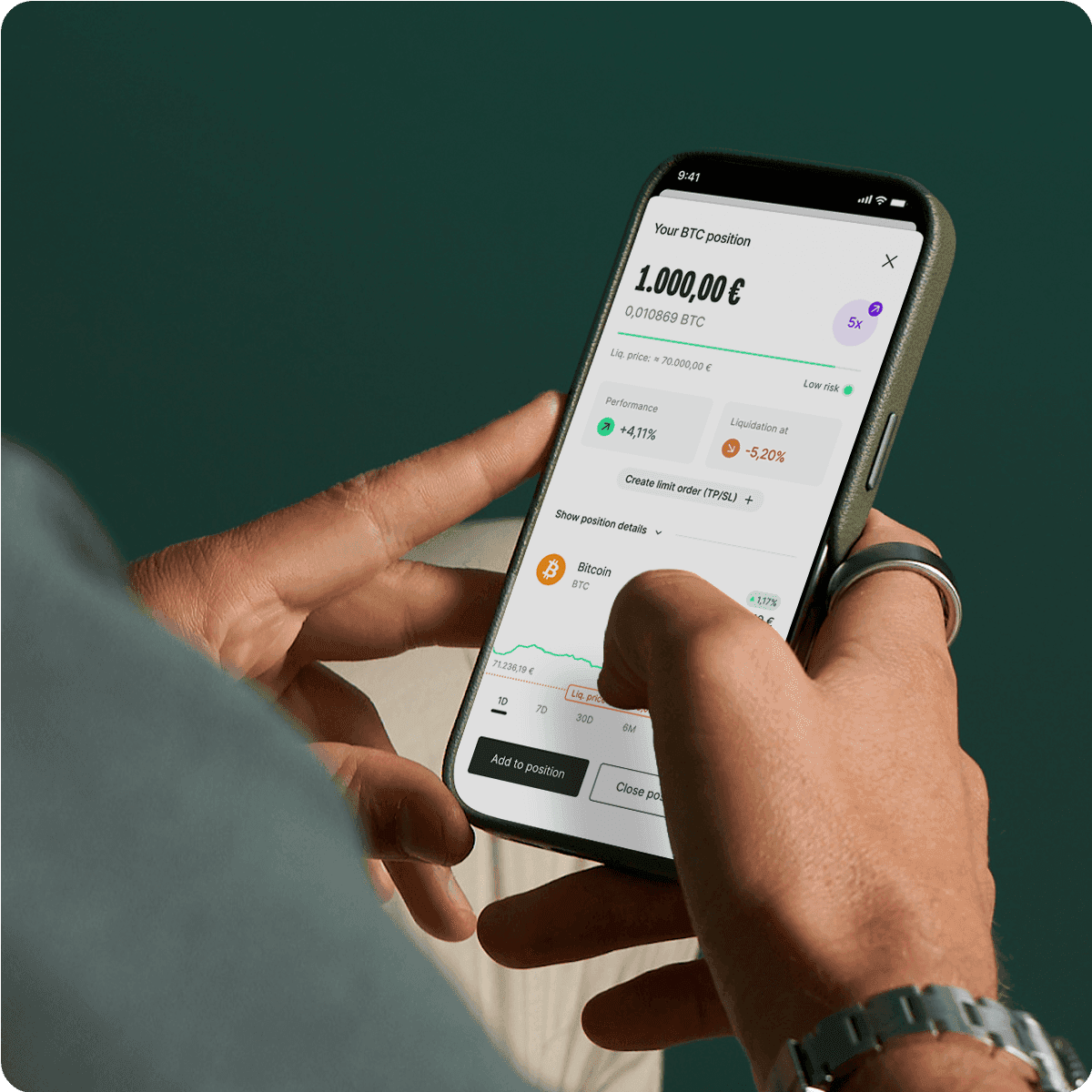 Person holding a smartphone displaying a cryptocurrency trading app with Bitcoin details and market trends visible.