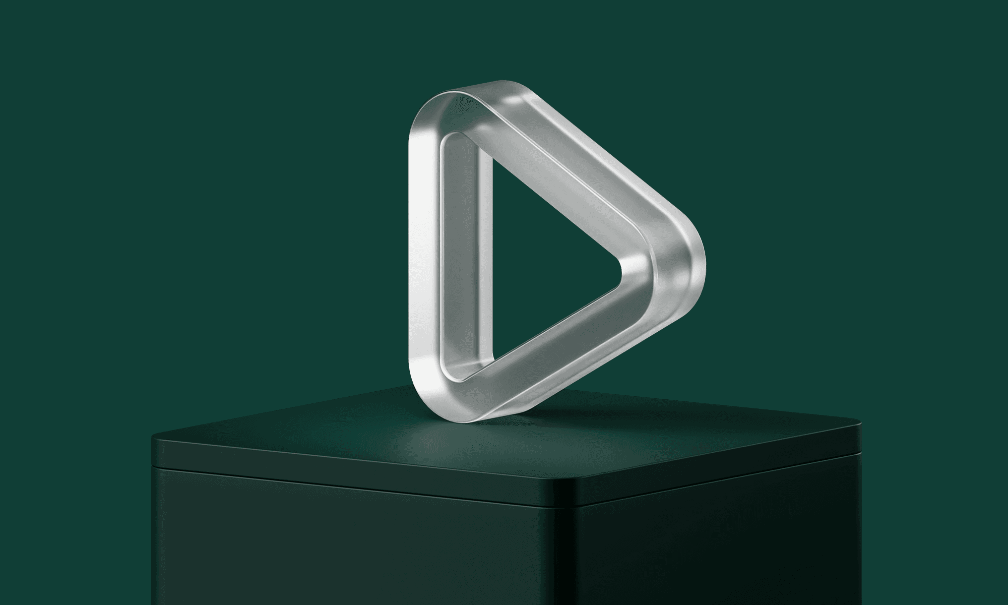 A metallic, triangular sculpture with rounded edges sits atop a dark green pedestal against a matching background.