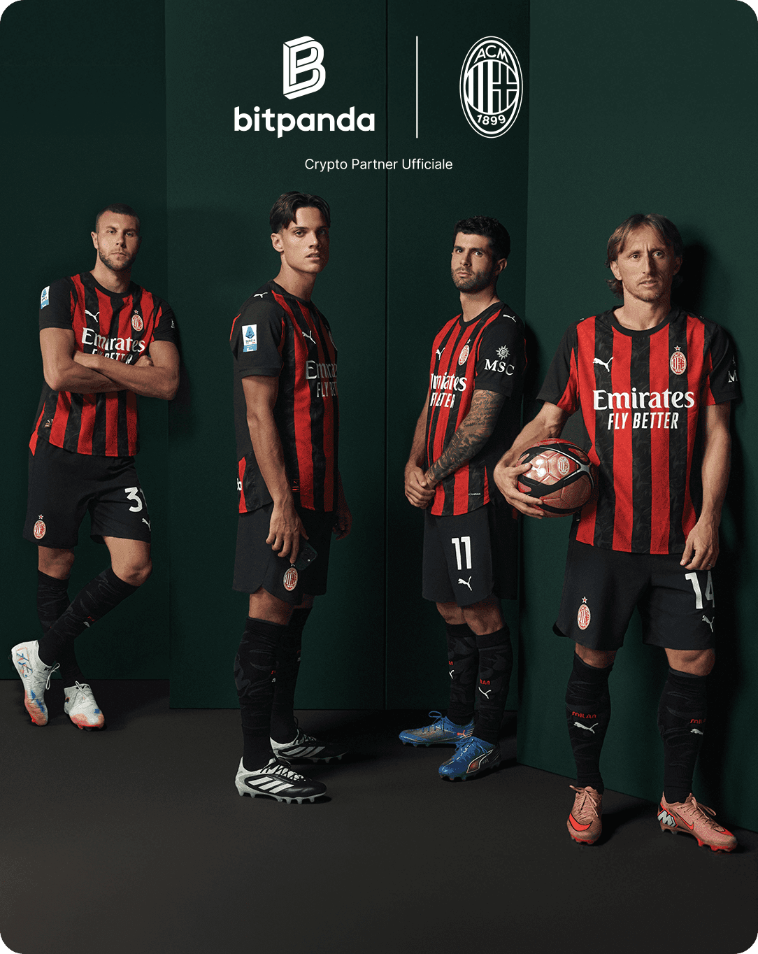 Four soccer players in AC Milan jerseys stand against a green backdrop, each posing confidently. Logos of Bitpanda and AC Milan are visible above.