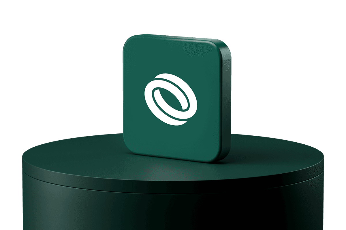 Dark green square block with rounded edges and a white interlocking ring logo, displayed on a matching green cylindrical pedestal.