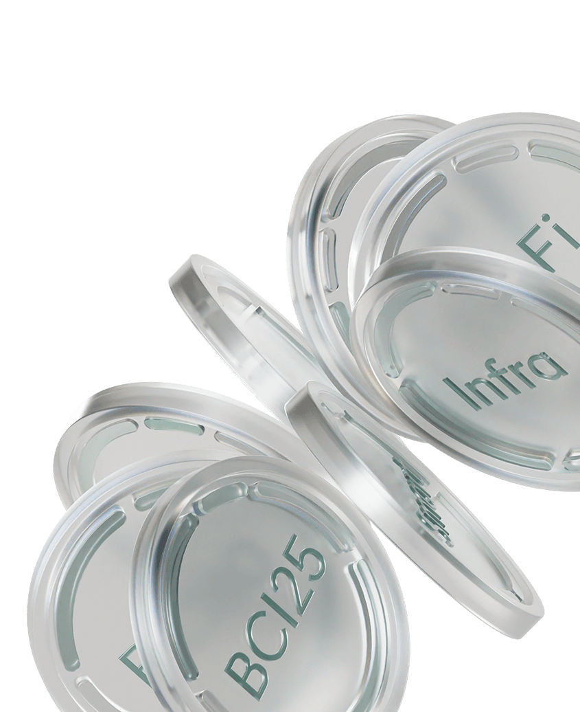 Stacked transparent circular plastic lids with teal text such as “BCI25” and “Infra” on a white background.